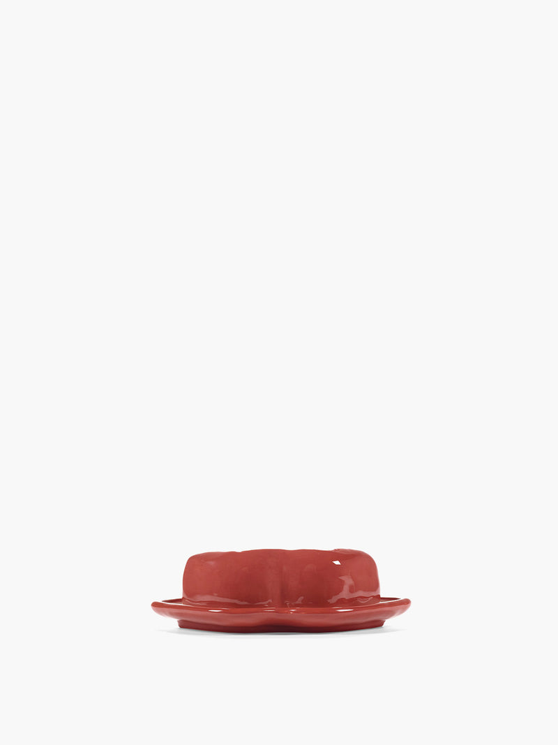 Red ceramic butter dish on a white background