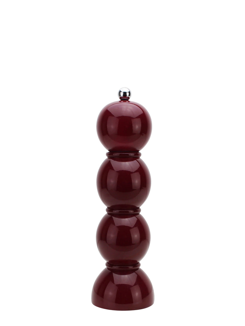 Wine red pepper grinder on a white background