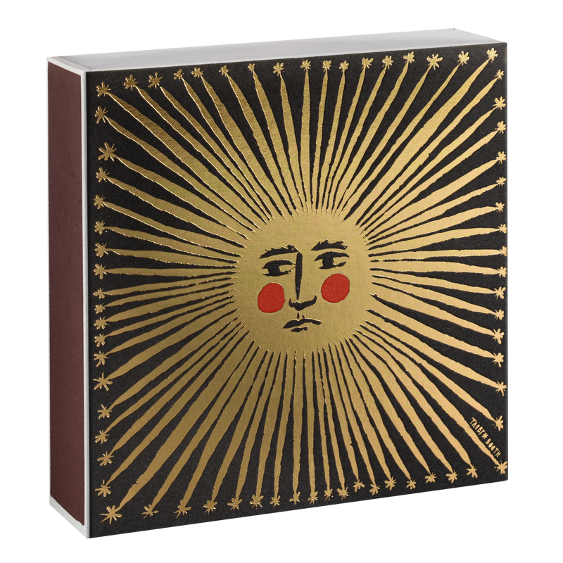 Decorative box with sun design and face on a black background