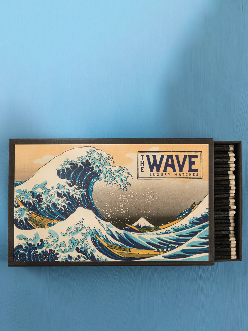 Matchbox with 'The Wave' design on a blue background