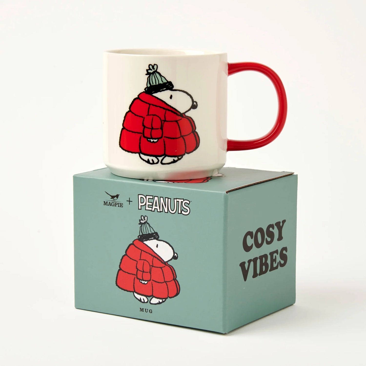Mug with cartoon snoopy character in a red coat on a matching box labeled 'Cosy Vibes'.