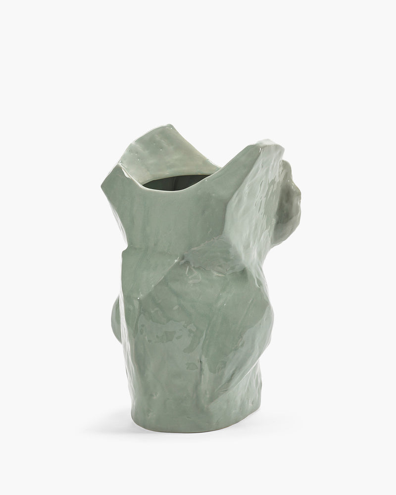 Light blue ceramic vase with textured surface on a white background