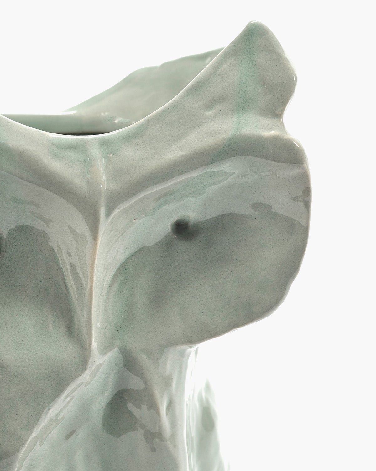 Abstract sculpture with smooth, flowing lines on a light background