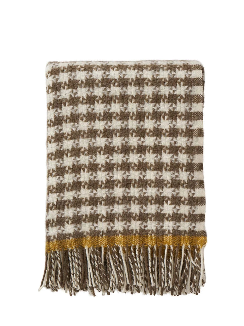 Houndstooth patterned blanket with fringes on a white background