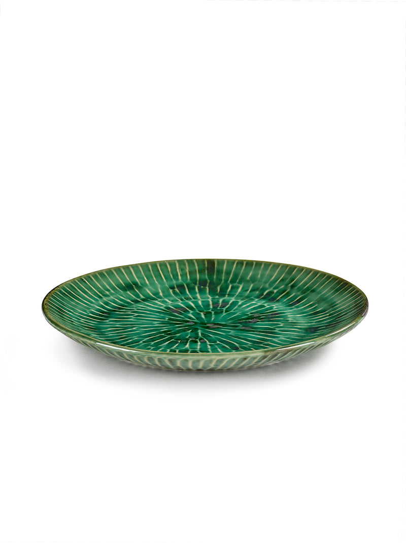 Green ceramic plate with textured design on a white background