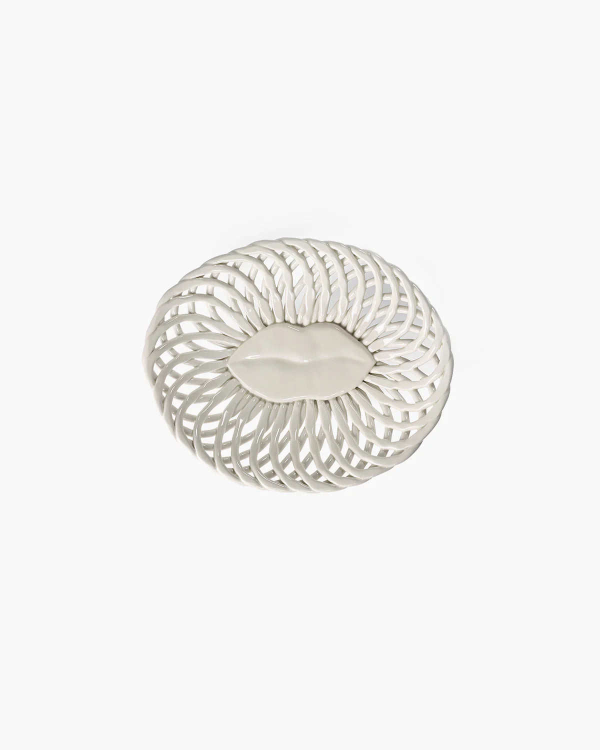 Decorative white plate with a leaf design on a white background