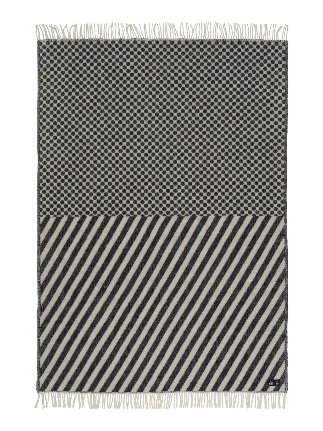 Black and white patterned throw blanket with fringes on a white background