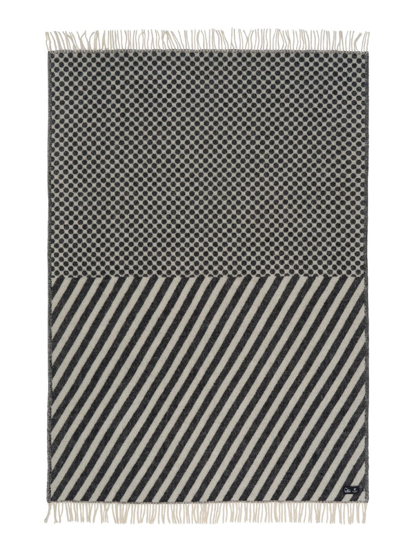 Black and white patterned throw blanket with fringes on a white background