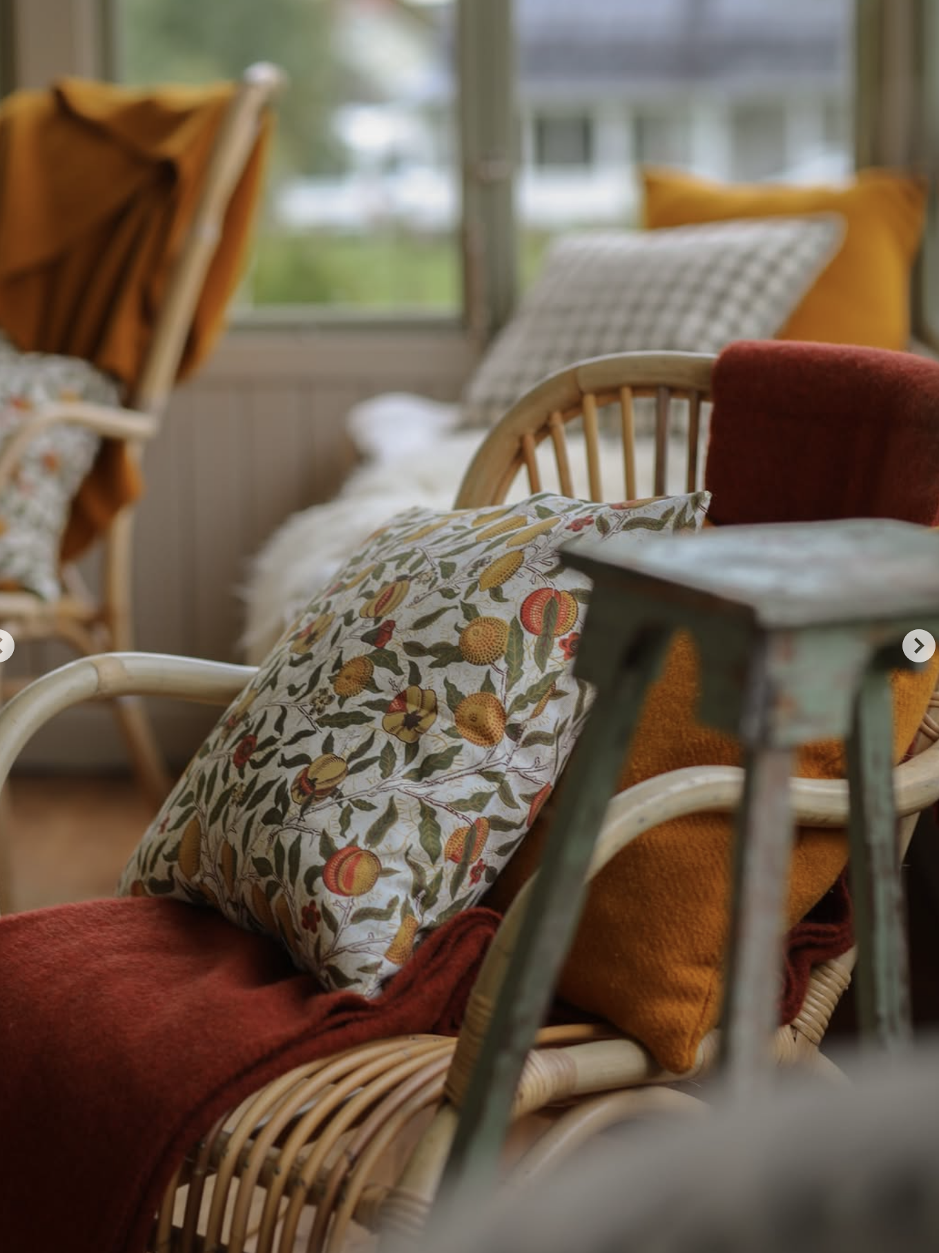 Cozy living room with wicker chairs and patterned cushions.