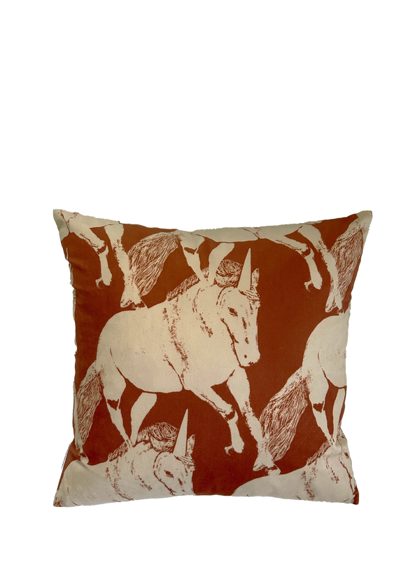 Decorative pillow with galloping unicorn pattern on a white background