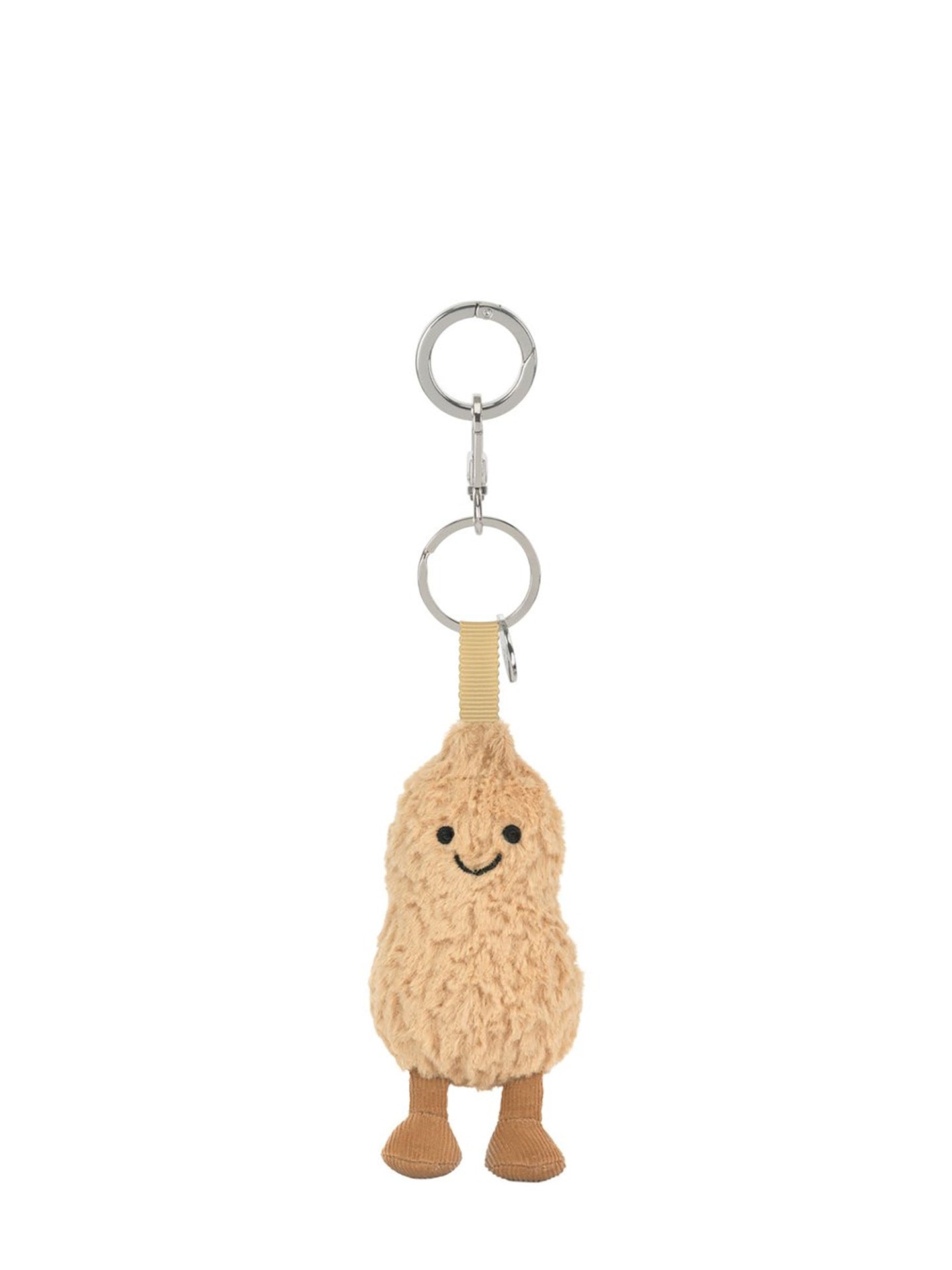 A plush peanut-shaped keychain charm with a smiling face, attached to a beige strap and silver metal key rings, shown on a plain white background.