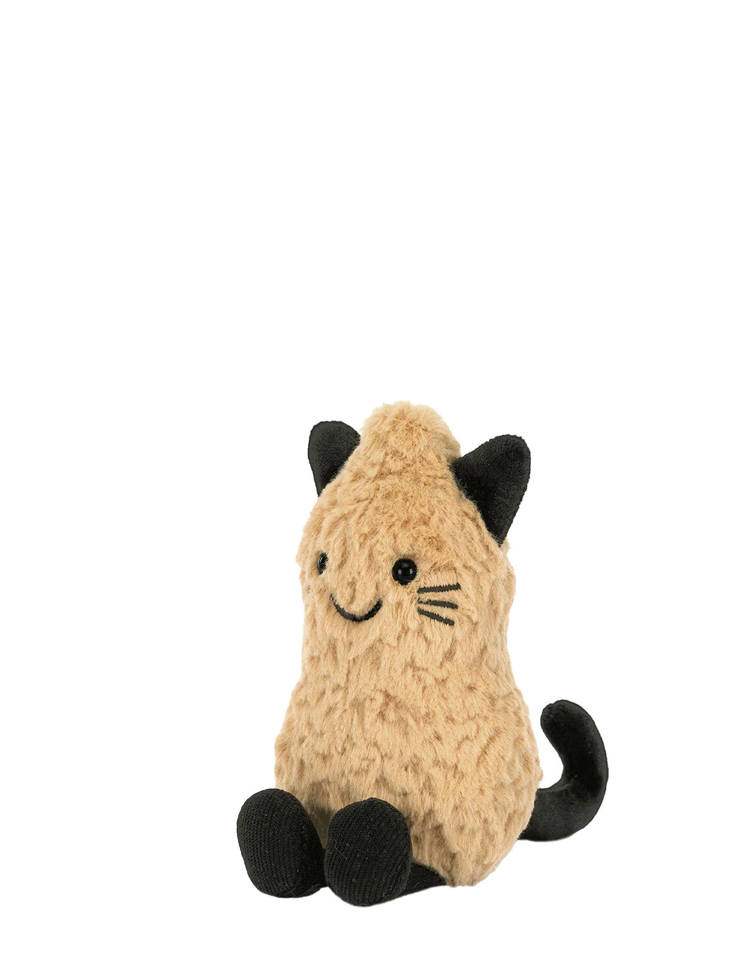 A small plush peanut toy dressed in cat costume with black bead eyes and embroidered smile and whiskers and black cat ears, black cat tail and two little feet in black pantyhouse sitting against a plain white background.