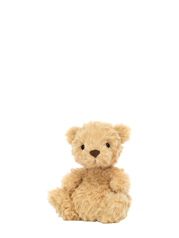 A small, plush teddy bear with a beige color and embroidered details on the face.