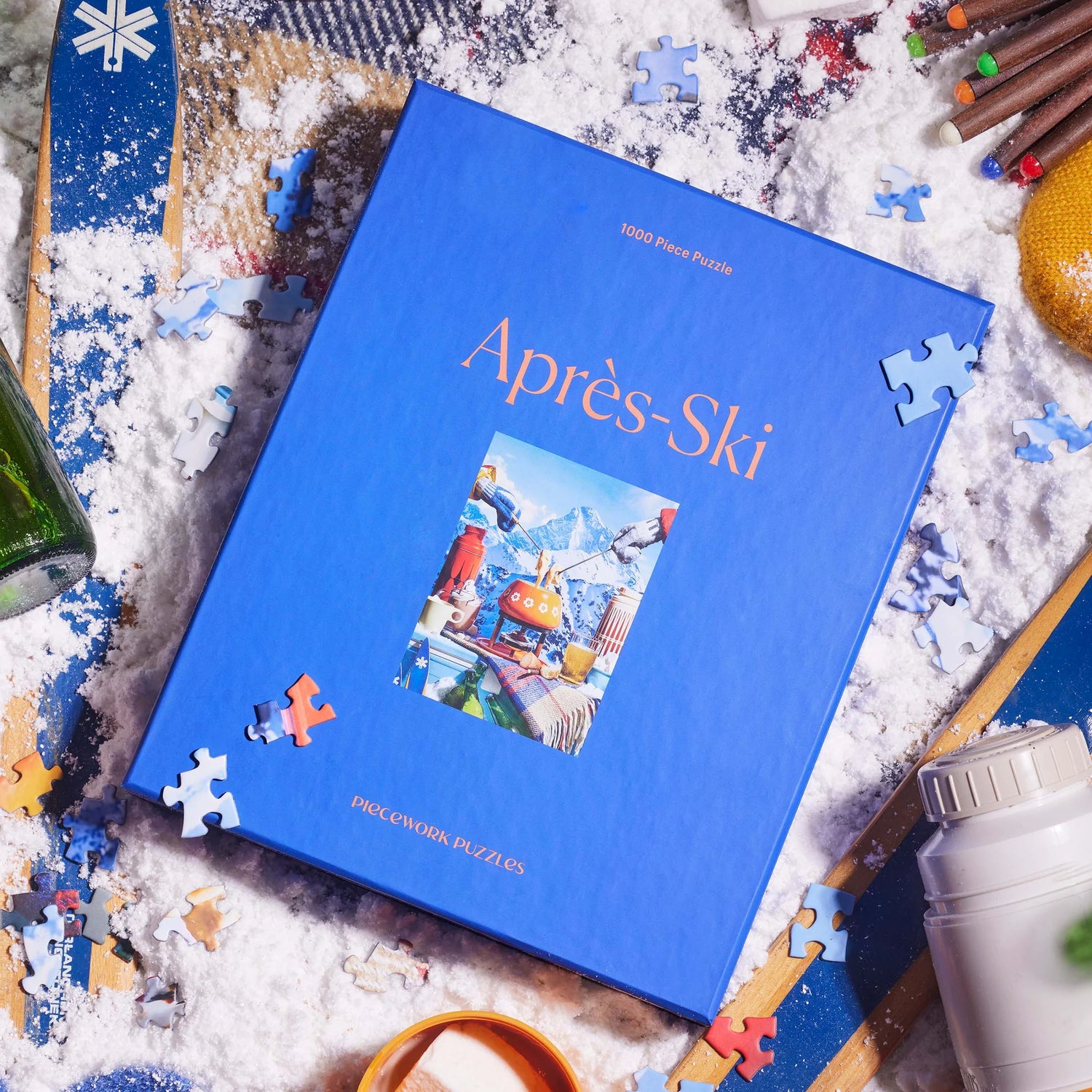 Puzzle bpx titled 'Ap
es-Ski' surrounded by puzzle pieces and ski-themed items on a snowy background
