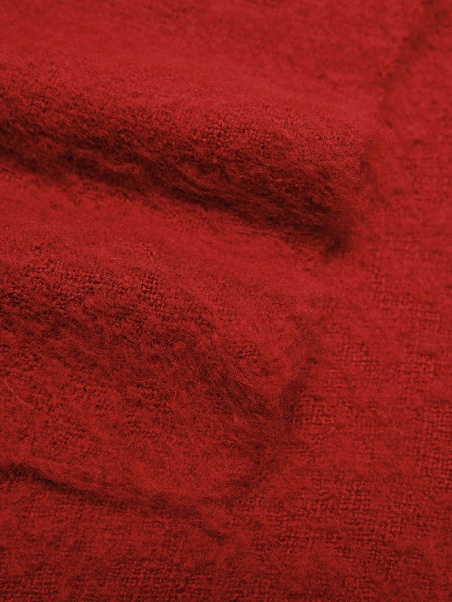 Close-up of red cashmere scarf with a textured pattern