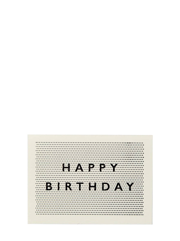 A minimalist square greeting card with a cream background, a black dotted grid pattern, and the words 'HAPPY BIRTHDAY' in black serif letters, shown against a solid white background.