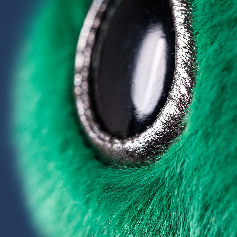 Close-up of a metallic object on green fur