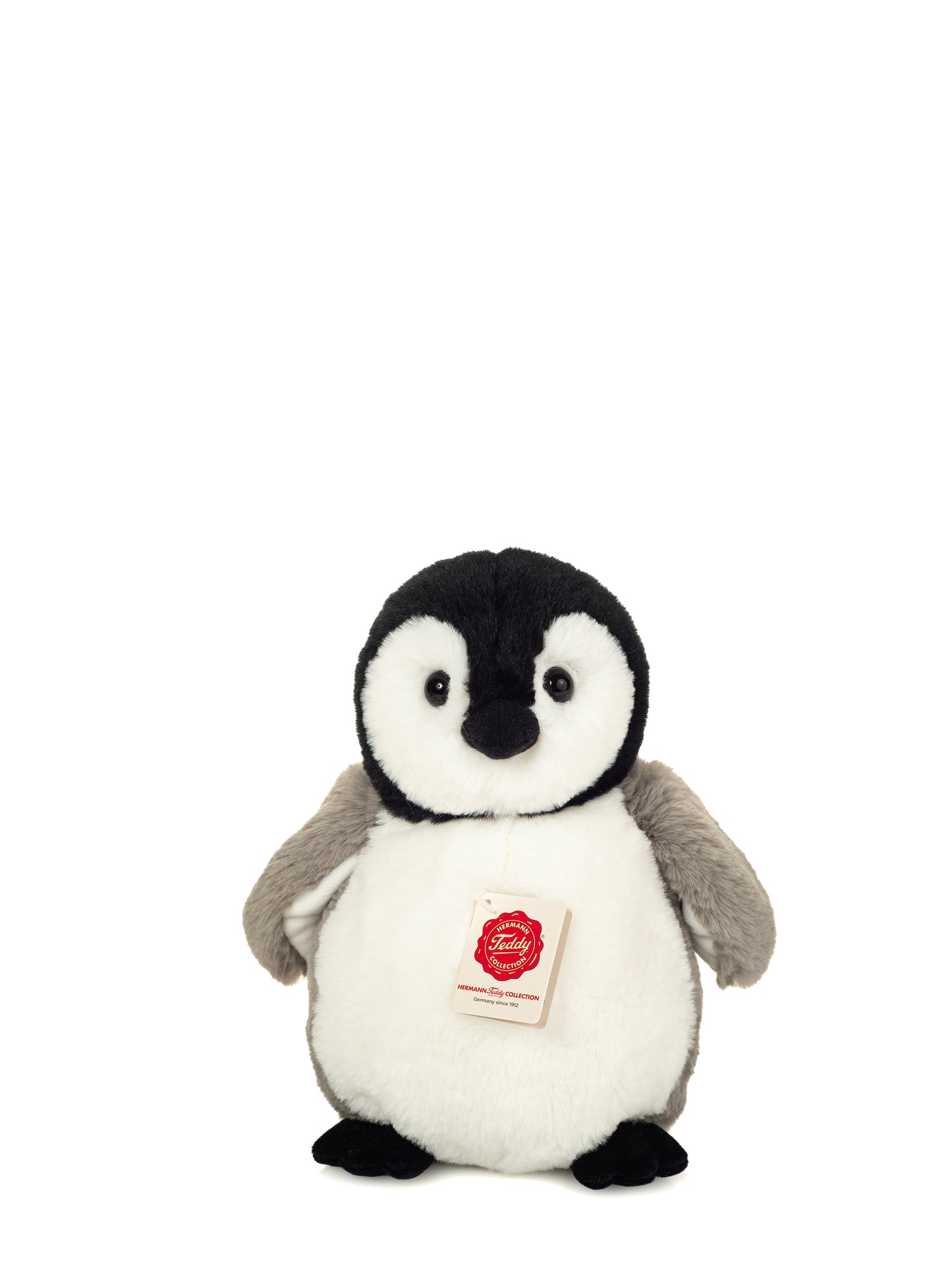 Stuffed penguin toy with a visible brand label on a white background