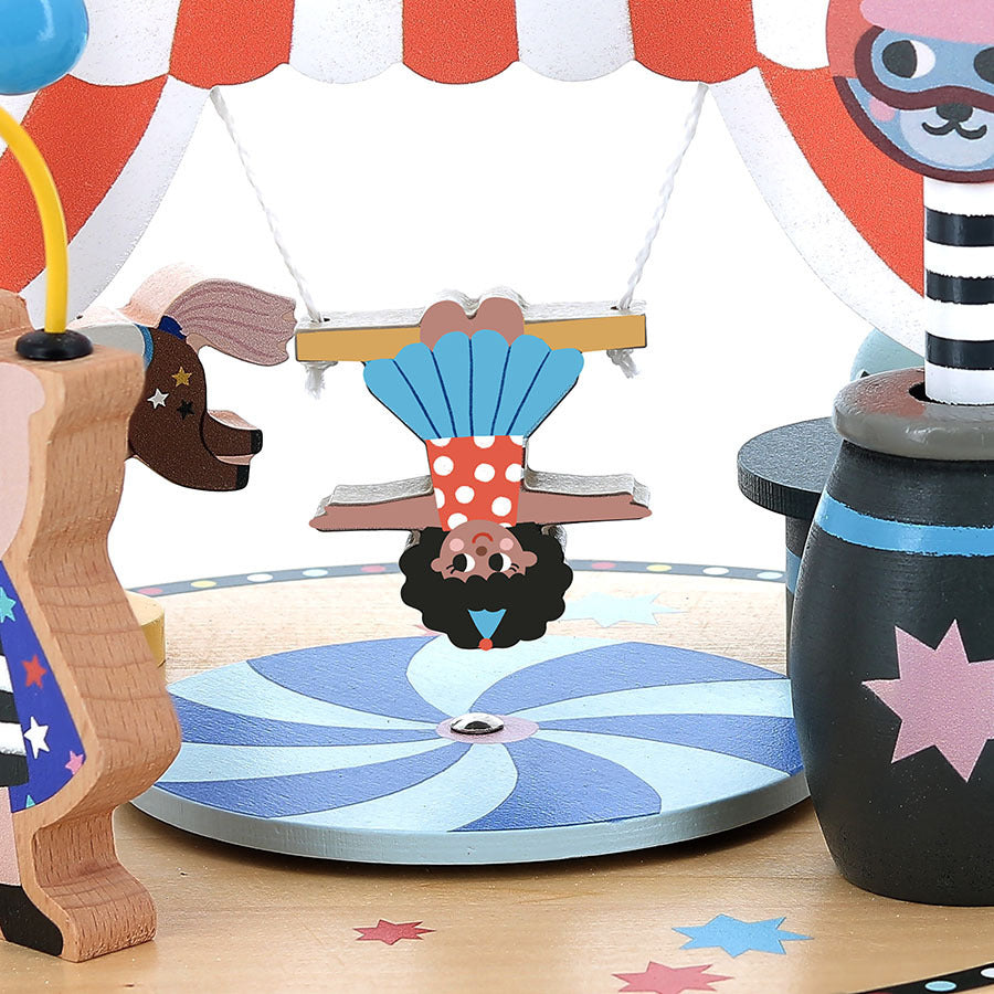 Toy carousel with a horse, clown, and other animals under a striped canopy.