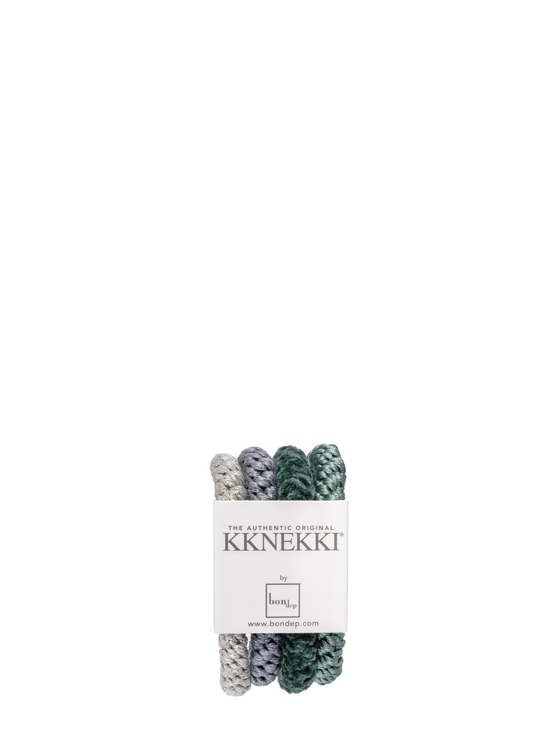 Four braided hair ties or ponytail holders in muted silver gray, blue-gray, forest green in velvet, and celadon green, bundled with a white paper label that reads 'The Authentic original KKNEKKI by BonDep.