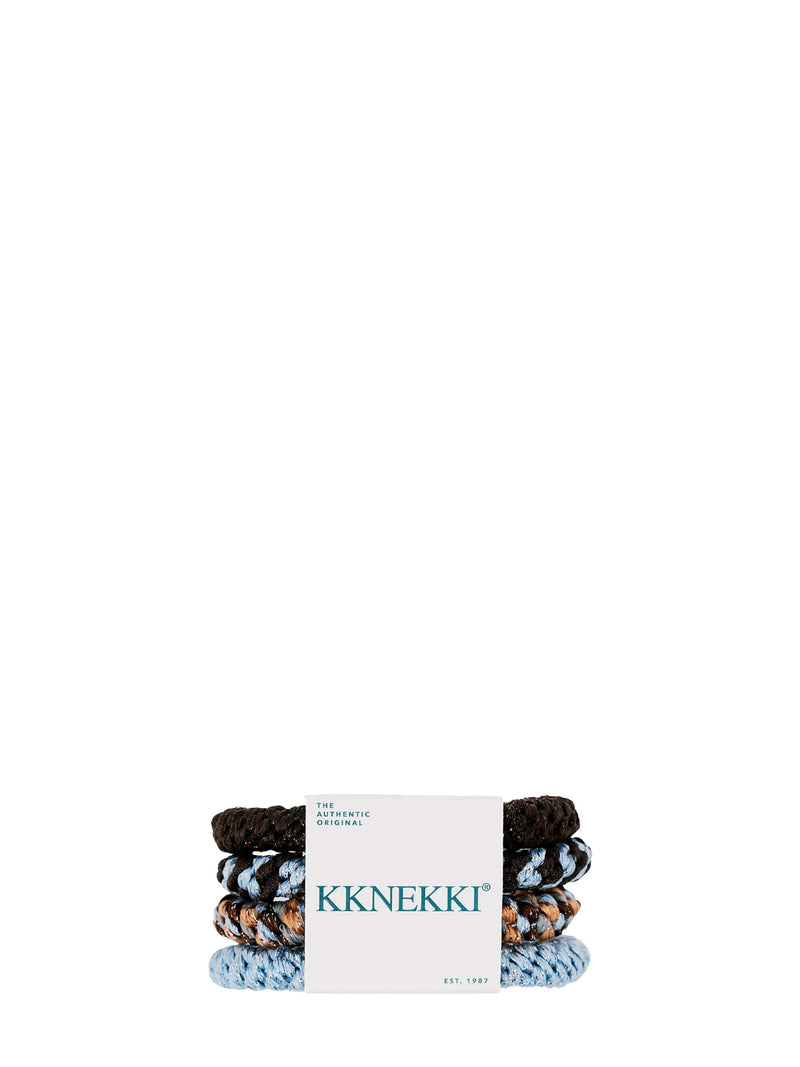 A set of four colourful hair ties or ponytail holders with little sparkles in them wrapped on a white waist  tie with a text 'The authentic original' on the left corner and 'Est. 1987 on the right corner' and big title 'KKNEKKI' in the middle, placed against white background. The hair tie colours of the set are from the  light bottom up a light blue, a mix of light blue, coral and dark brown, a mix of light blue and dark brown, with dark brown solid at the top.