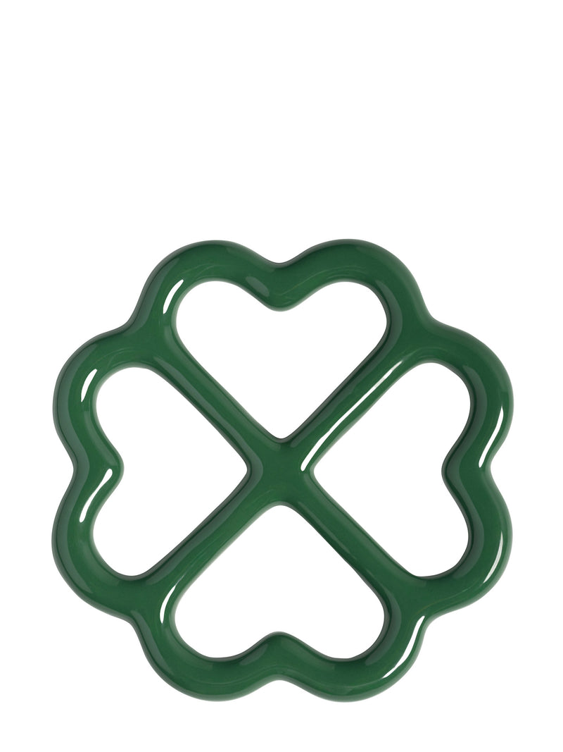 A dark green four-leaf clover shaped glazed trivet, shown from upward on a plain white background.