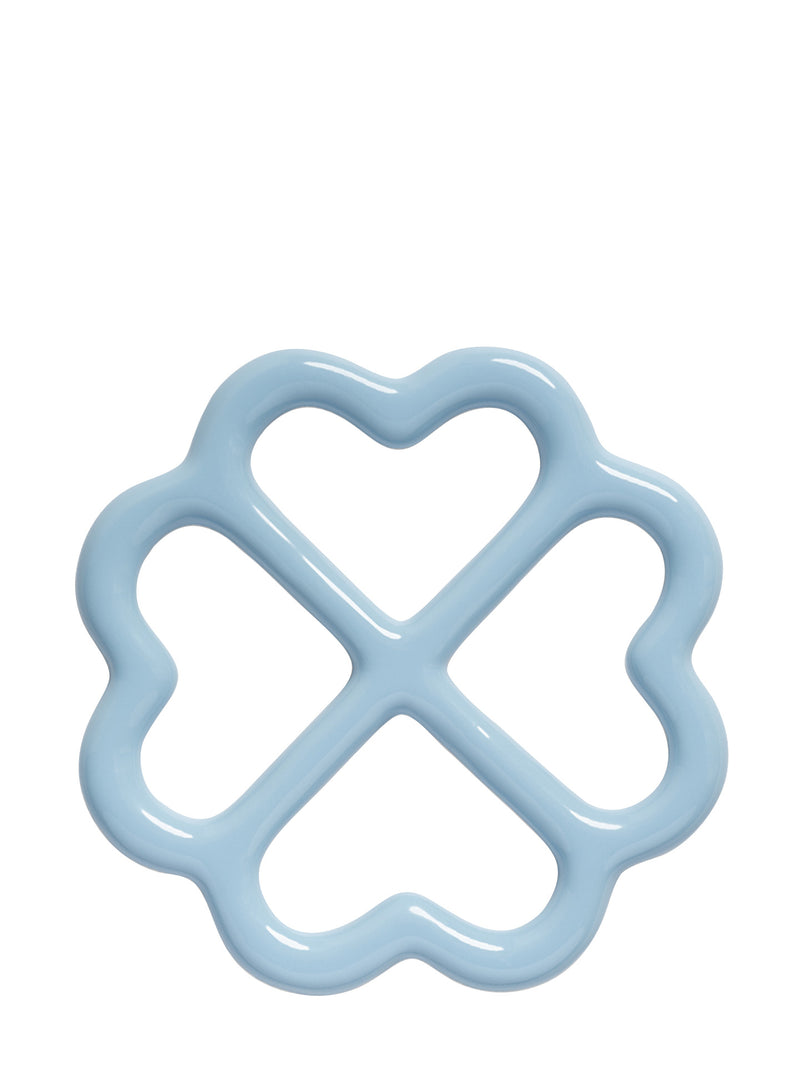 A light blue glazed trivet with a wavy flower-like border and four heart-shaped sections, shown on a solid white background.