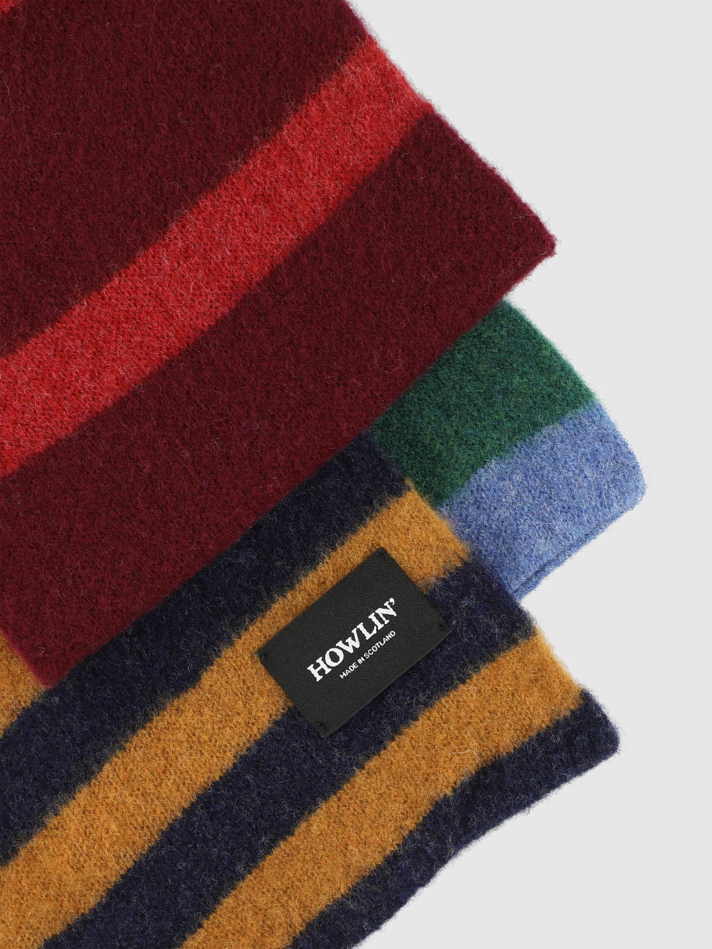 Stack of striped fabric swatches with 'HOWLIN' label on a white background