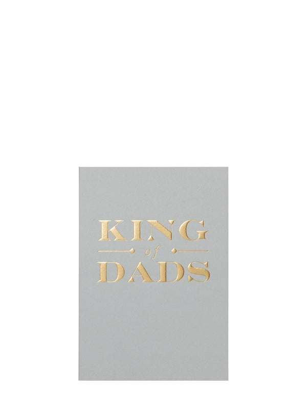 A rectangular gray card or print with metallic gold foil text reading 'KING of DADS' centered on a plain white background.