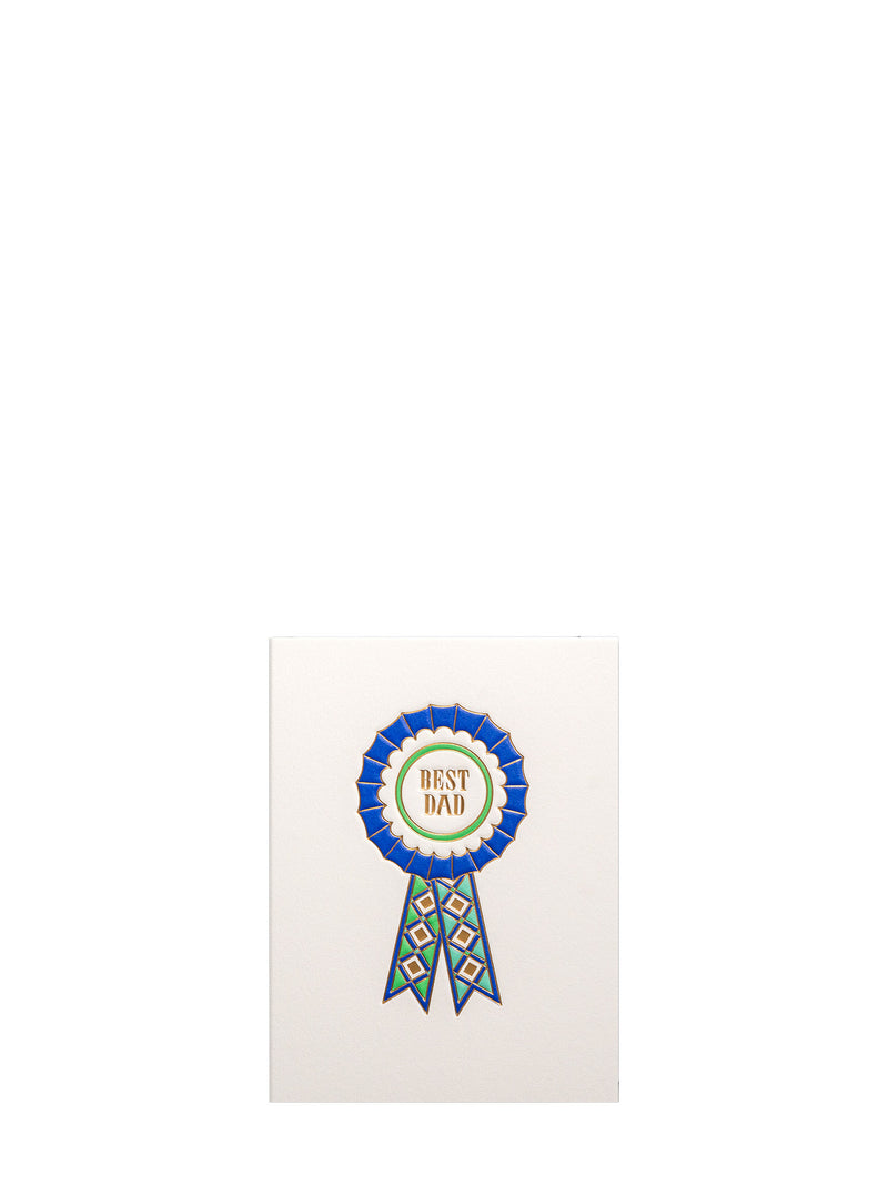 A white greeting card featuring a blue and green rosette ribbon graphic with the words 'BEST DAD' in gold on a white circular center, shown against a plain white background.