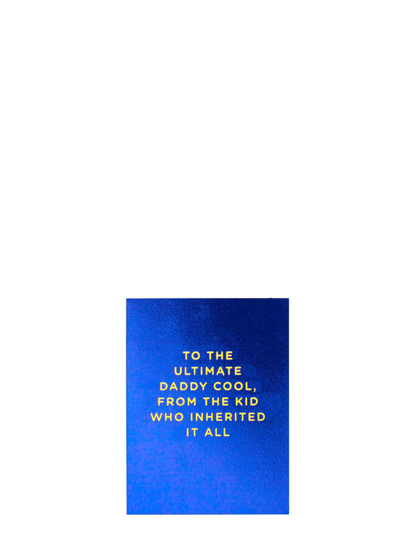 A rectangular blue card or print with gold text reading, 'TO THE ULTIMATE DADDY COOL, FROM THE KID WHO INHERITED IT ALL,' centered on a plain white background.