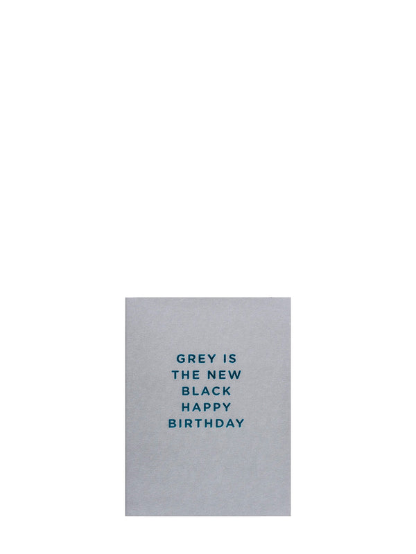 Sleek mini gard with text 'Grey is the new black happy birthday' on teal blue font on matte grey solid base