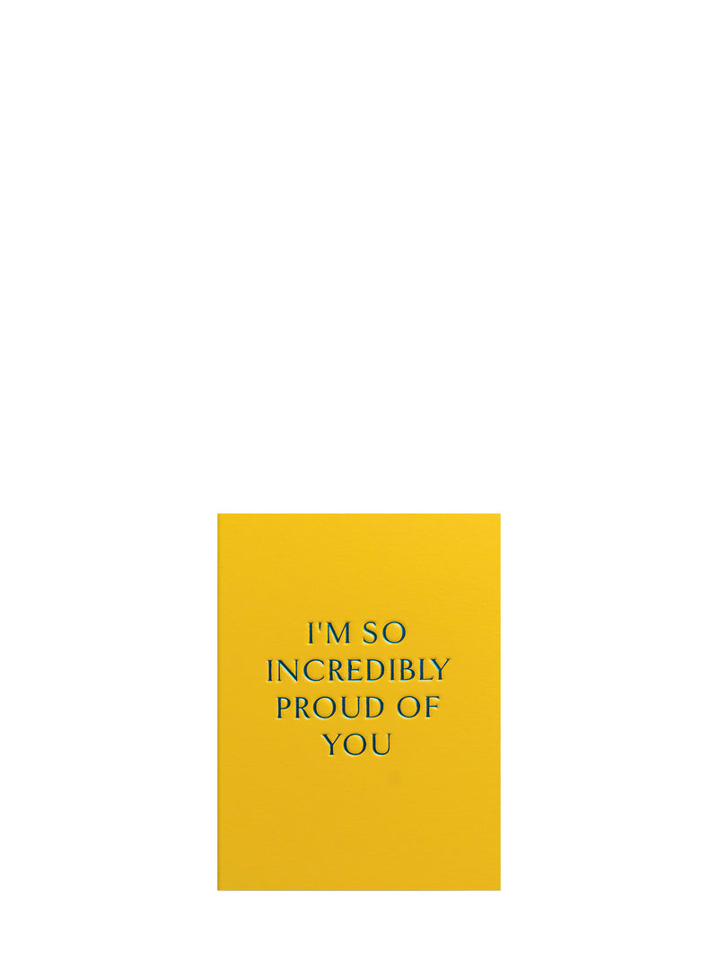 Yellow card with blue text 'I'm so incredibly proud of you' on a white background
