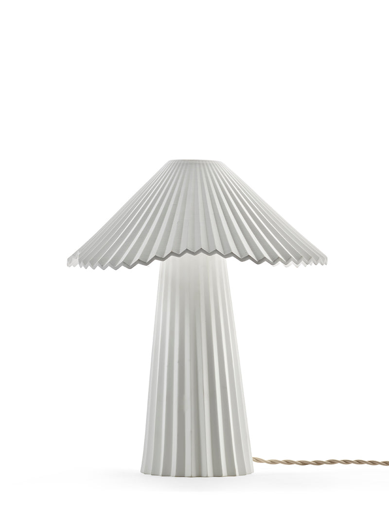 Table lamp with pleated design on a white background