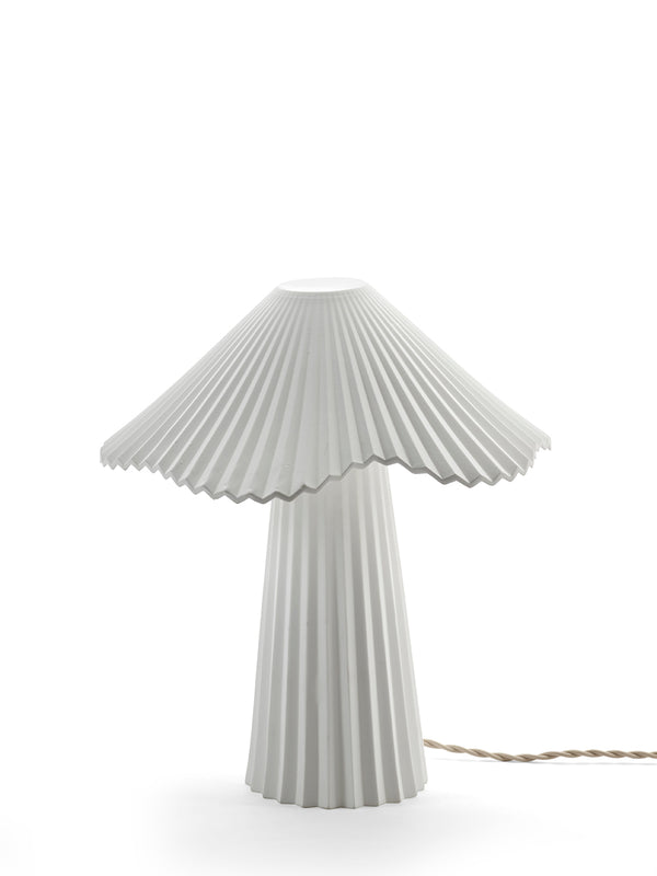 Table lamp with pleated design on a white background