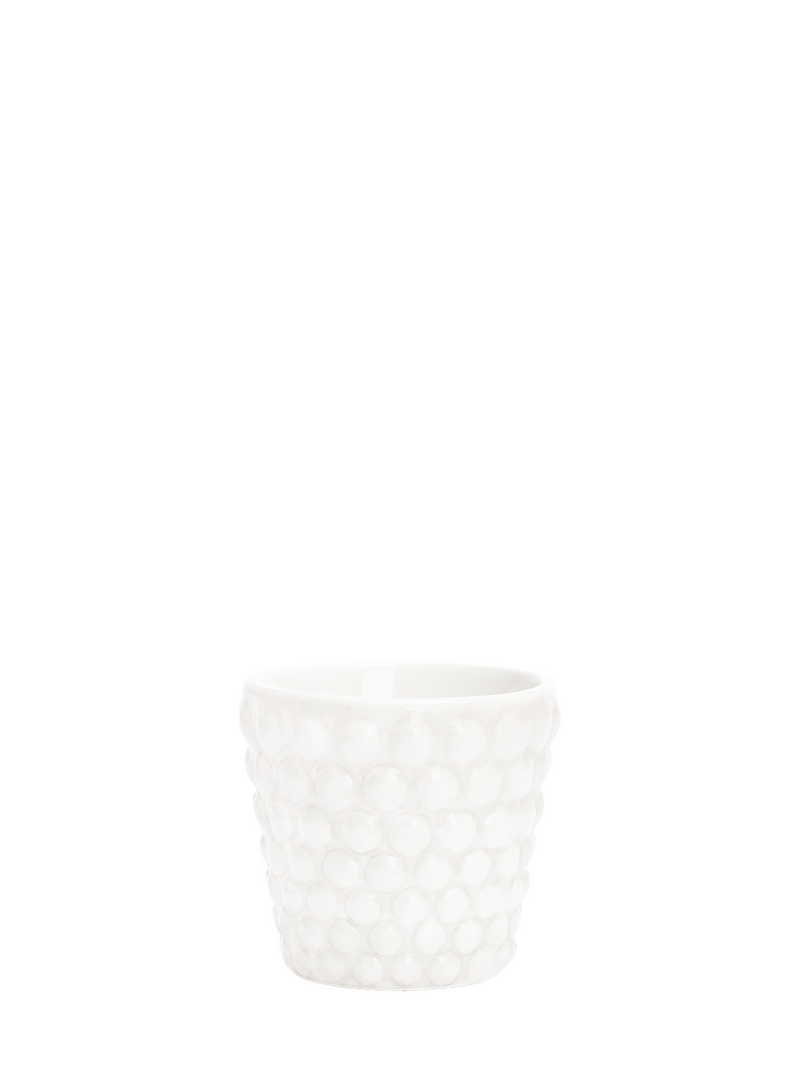 A white ceramic espresso cup with a bubble pattern design.