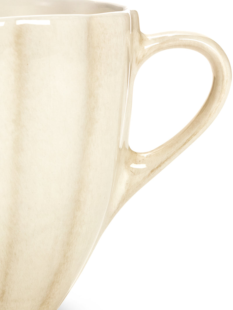 Beige ceramic mug on a white background