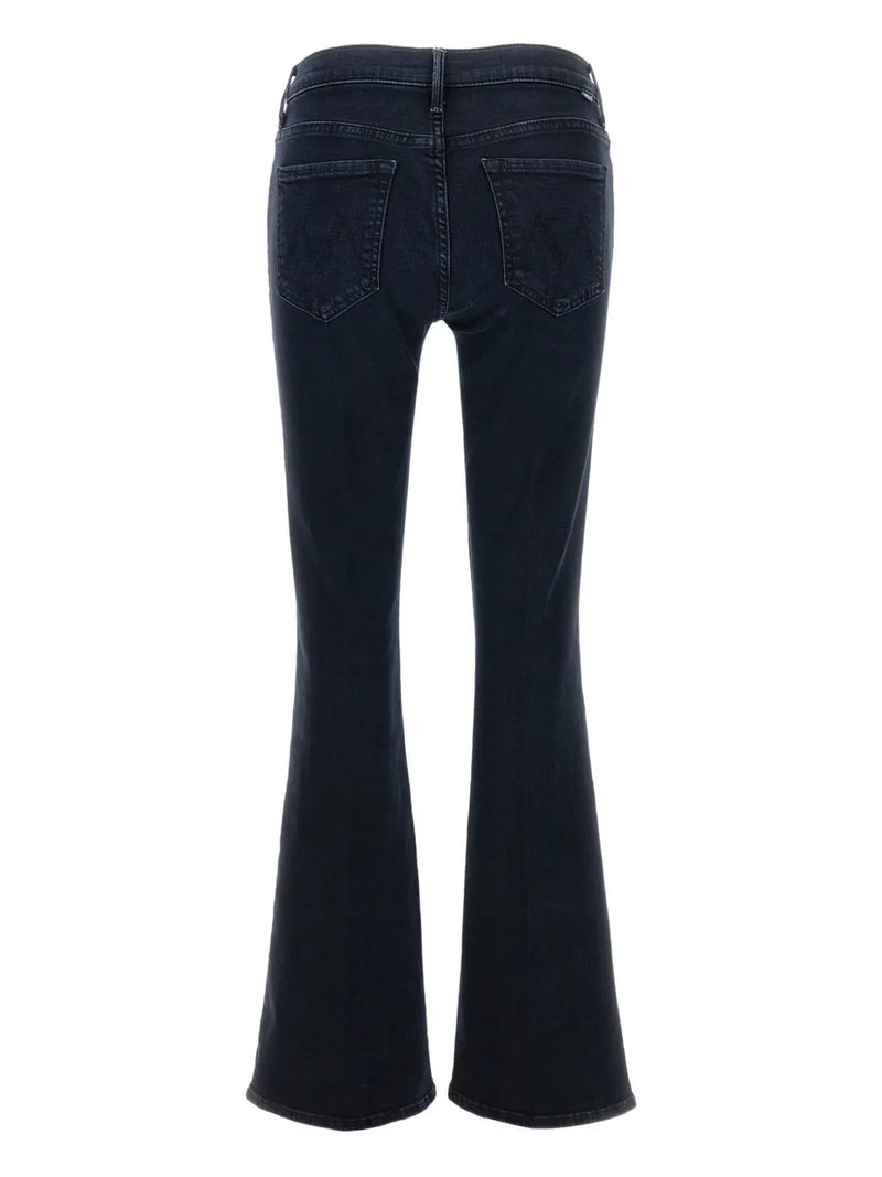 Dark blue flared jeans on a white background