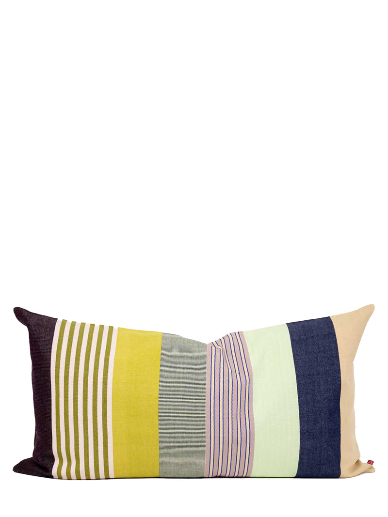 A rectangular lumbar throw pillow with a vertical striped patchwork design in mustard yellow, olive green, gray, pink, mint green, navy blue, and beige, shown against a plain white background.