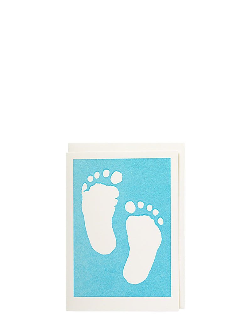 Framed artwork with white footprints on a blue background
