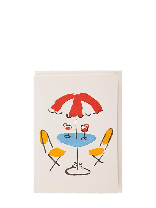 Colorful illustration of a table with two chairs and an umbrella on a white background