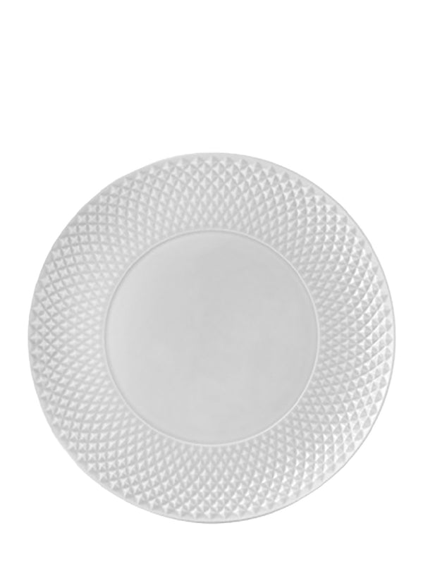 White decorative plate with textured rim on a white background