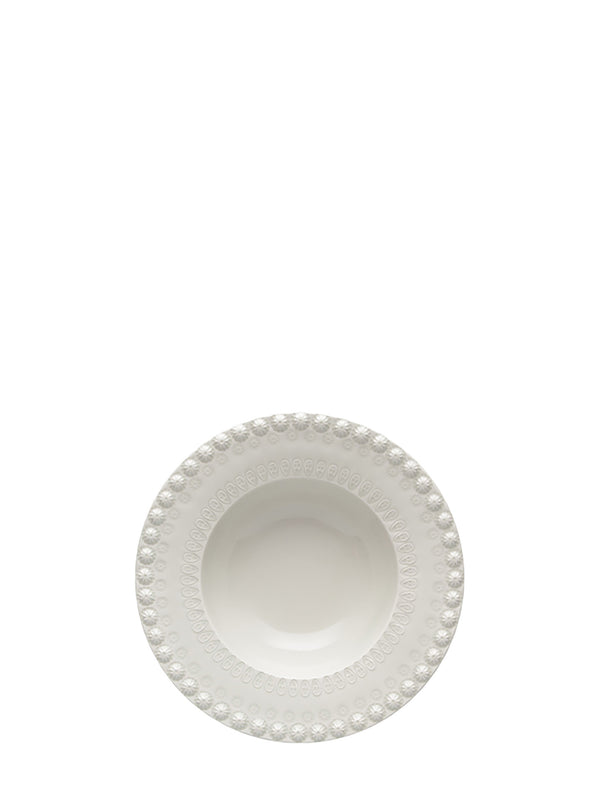 White ceramic bowl with decorative rim on a white background