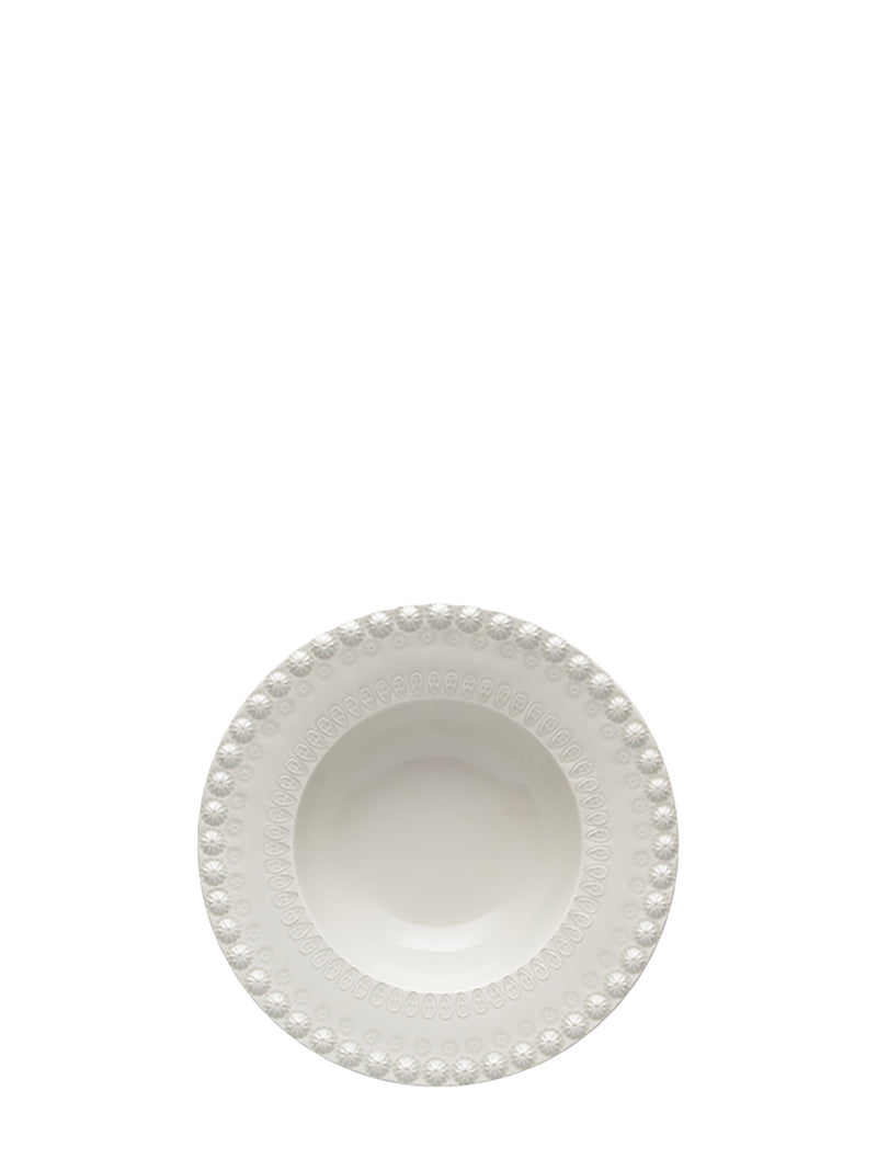 White ceramic bowl with decorative rim on a white background