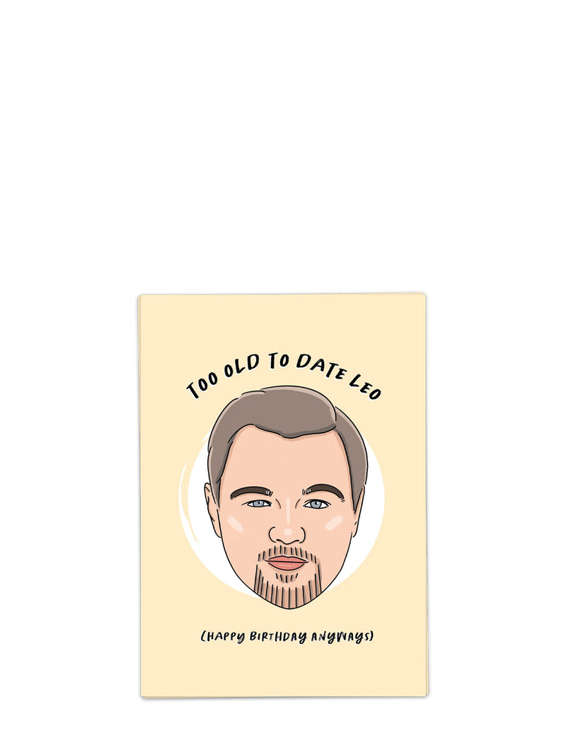 Greeting card with a caricature of a man's face and text 'Too Old to Date Leo (Happy Birthday Anyway)' on a beige background.