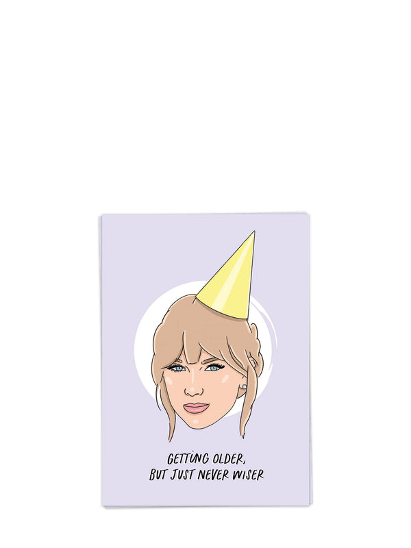 Card with illustration of Taylor Swift wearing a party hat and text 'Getting older, but just never wiser' on a light purple background.