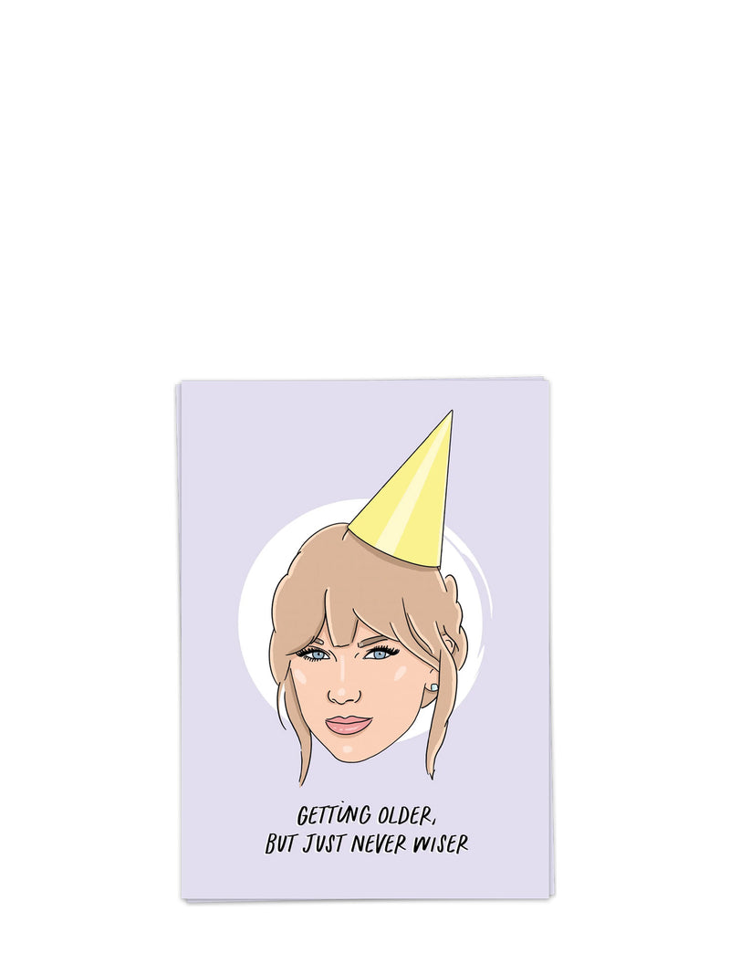 Card with illustration of Taylor Swift wearing a party hat and text 'Getting older, but just never wiser' on a light purple background.