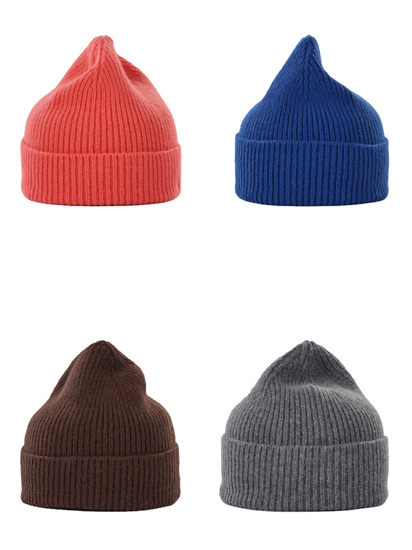Four ribbed knit beanie hats arranged in a 2x2 grid on a white background, shown in coral red, royal blue, dark brown, and heather gray.
