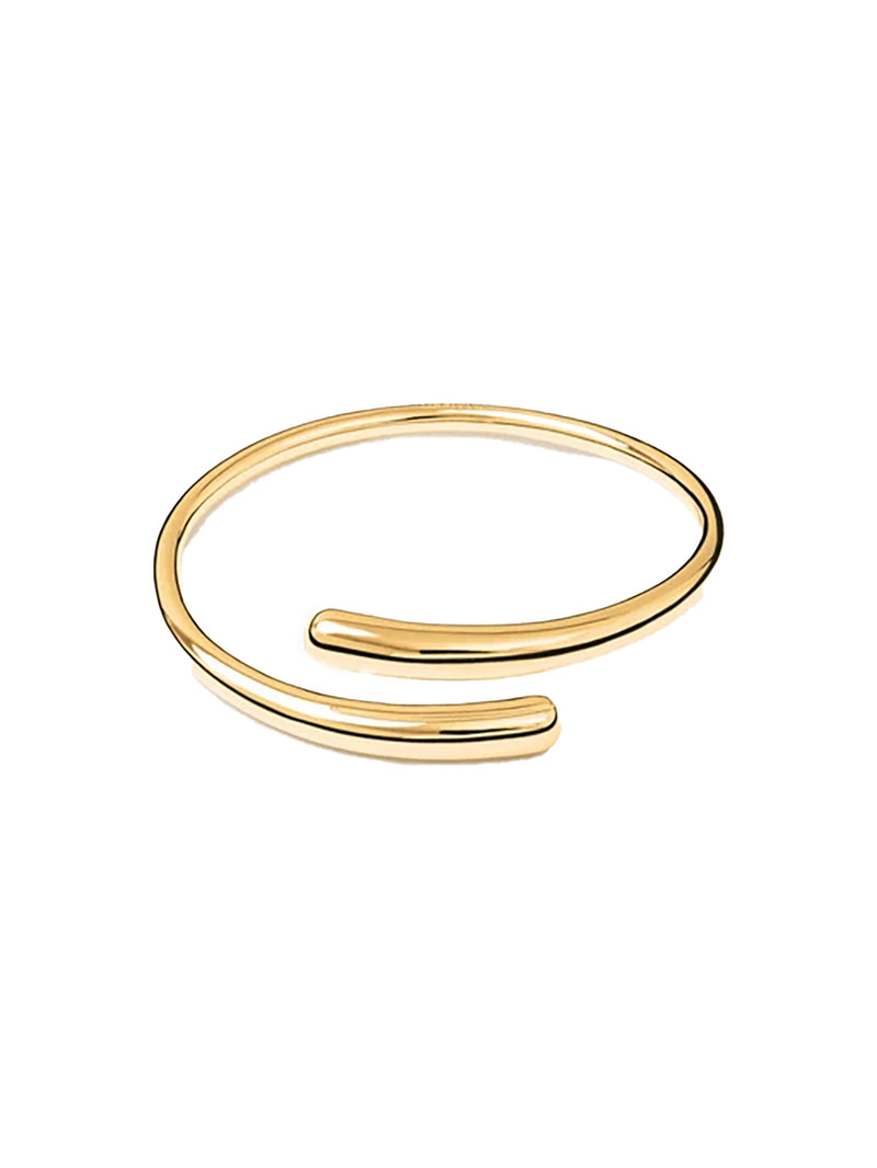 A thin, polished gold-tone open cuff bangle bracelet, shown on a clean white background.