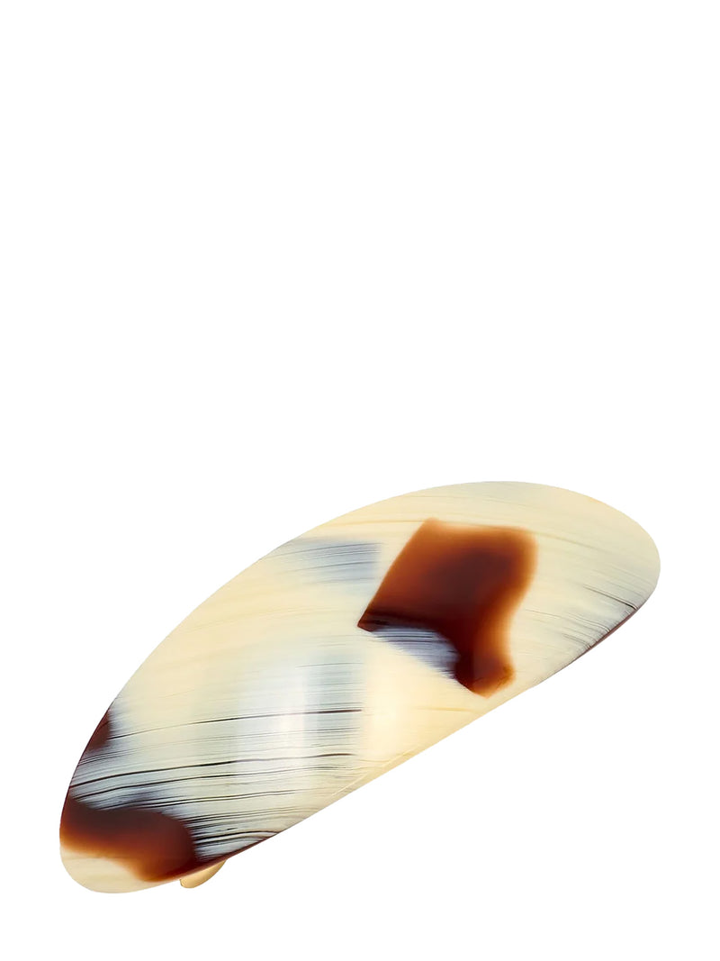 A tortoiseshell hair claw clip with a glossy, marbled pattern of cream, brown, and black, shown on a plain white background.
